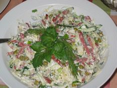 Fresh cabbage salad with ham and peas.